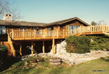 Cedar Deck with Log Rail and Bridge over Waterfall